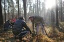 Two volunteers planting a deciduous seedling within an established forest. The planting location is in Landschaftsschutzgebiet Grunewald, Berlin, Germany near the Krumme Lanke subway station. The planting event was organized by aufBuchen eV, a conservation NGO based in Berlin. | Photographed using a Sony a6700 APS-C format camera | ISO 6709:2022 +52.45630+013.20750/ | Camera timestamp information in UTC | Metadata timestamp 02-Dec-2024 23:57:43 +0000 (UTC)