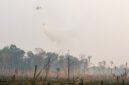Helicopter of water bombing, was helping them to watered peat soils. Often, watered the flame.